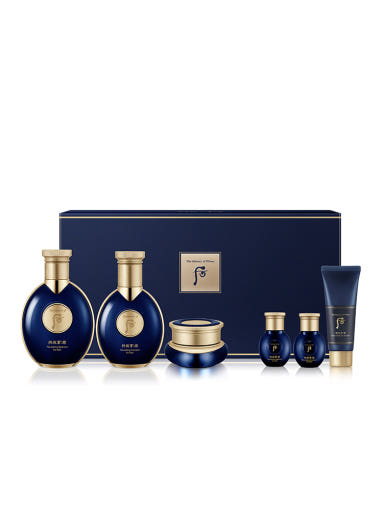 Cosmetic set with blue and gold bottles and containers on a white background
