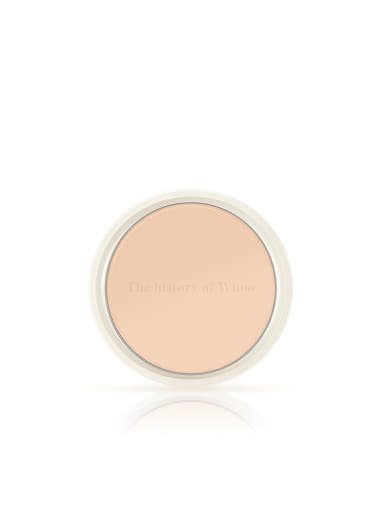 Compact powder in a round container on a white background