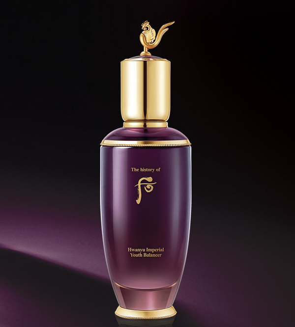 Purple skincare bottle with gold cap on a dark background